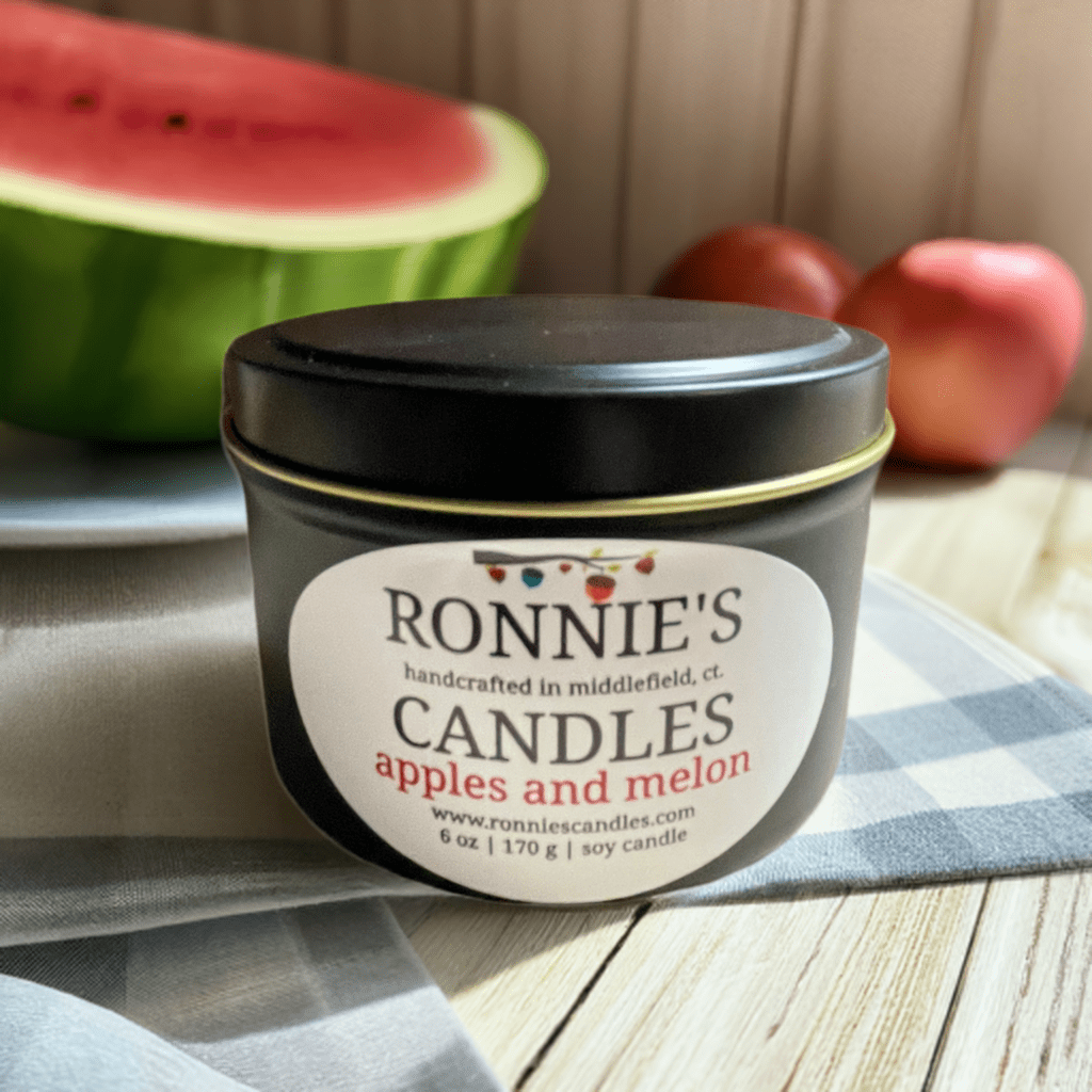 Soy candle emitting strong scent of fresh apples and juicy melon, perfect for aromatic home ambiance