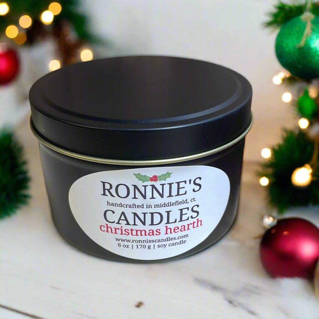 Elegant Christmas candle flickering by a luxurious fireplace, filling the air with rich holiday scented candle aromas.